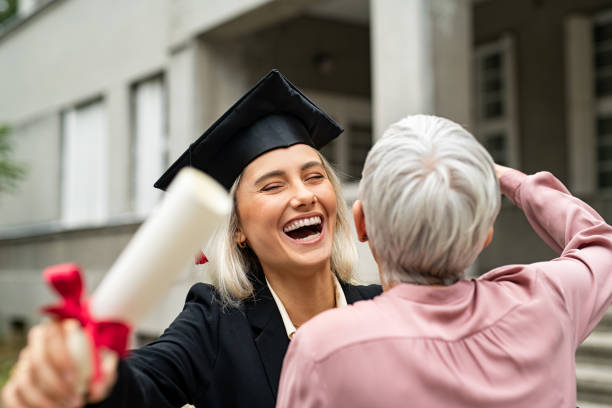 istock Laughing graduate student embracing mother 1201408905