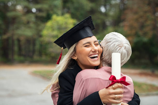 istock Graduate girl hugging mother 1201408911