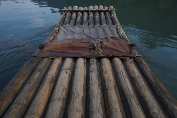 Head of a bamboo raft on water stock photo