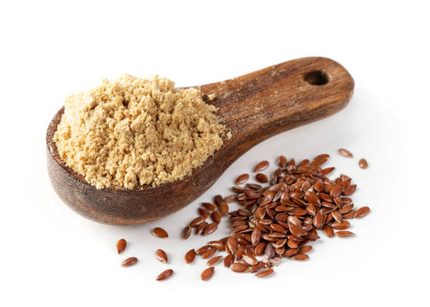 Linseed flour in a wooden spoon Linseed flour in a wooden spoon isolated on a white background flax seed stock pictures, royalty-free photos & images