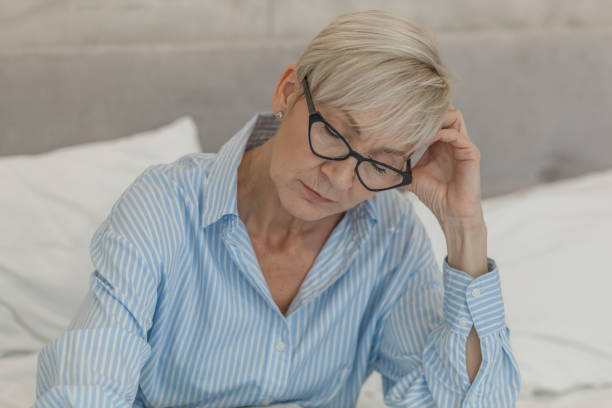 istock Pensive woman in bed 1201411792