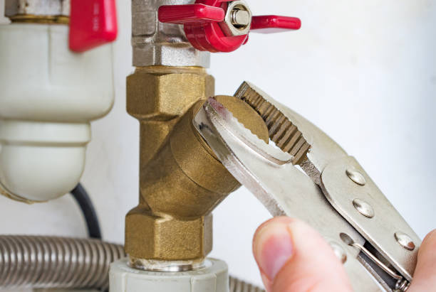 istock Plumber serves the coarse water filter of a heating boiler. Plumbing work. Selective focus. 1201412408