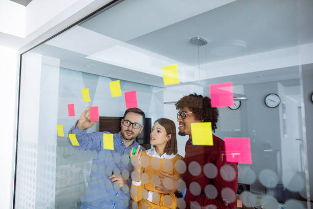 istock Business people brainstorming ideas behind glass wall 1201412937