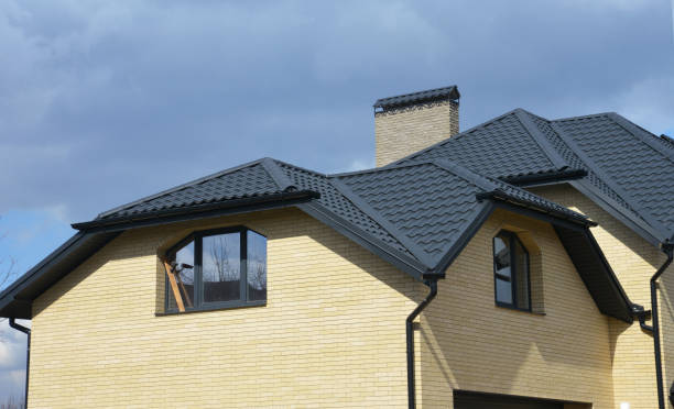 istock Valley and gable house ceramic tiled roofing construction with gutter pipeline. Brick house with problem gable roof roofing construction and roof gutter pipeline system. 1201413674