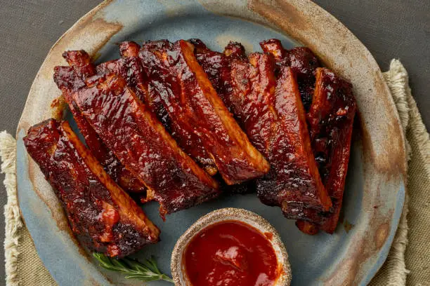 Keto food, spicy barbecue pork ribs. Slow cooking recipe. Pickled Roasted Pork Meat with red sauce. Asian Cuisine, Korean.