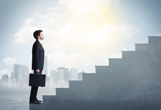 istock Businessman climbing up a concrete staircase concept 1201415840