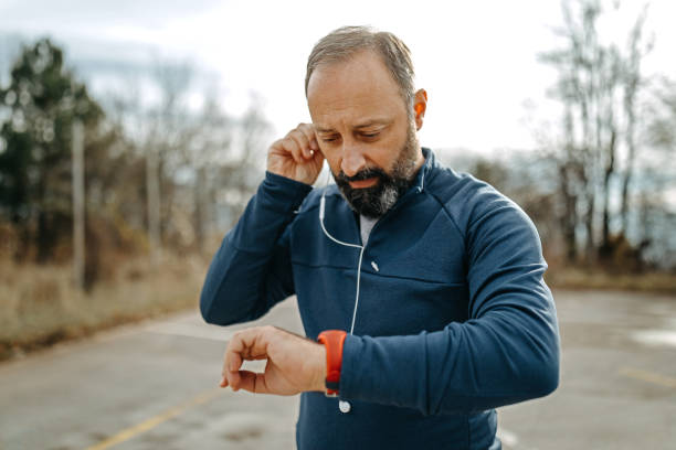 istock Mature men running and using smart watch outdoors 1201415864
