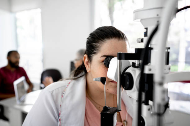 istock Female optometrist measurement with optical phoropter in ophthalmology 1201416075
