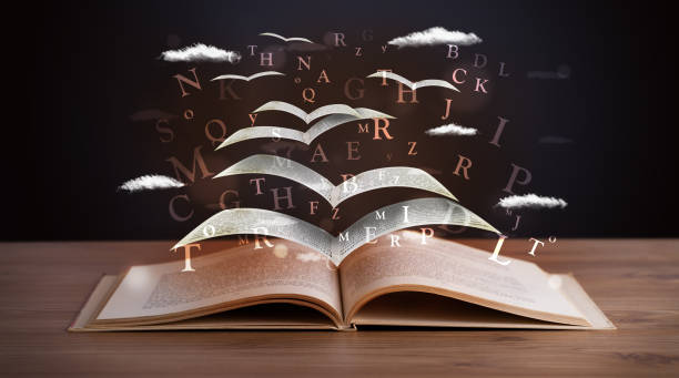 istock Pages and glowing letters flying out of a book 1201417526