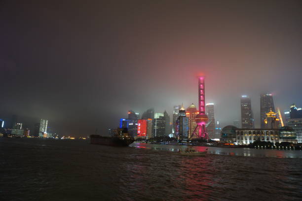 Tower of Shanghai illuminated in fog at night stock photo