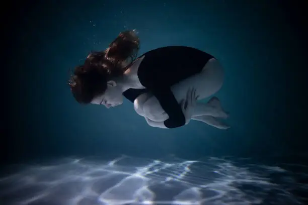 Photo of Young Slender Girl Underwater with a Cloth. Water Magic. Underwater Photography. Art
