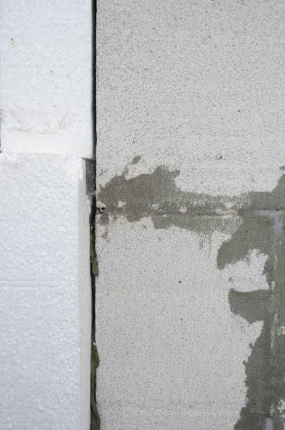 istock External house wall insulation layers with styrofoam. Installing rigid foam insulation board on house wall outdoors. 1201422488