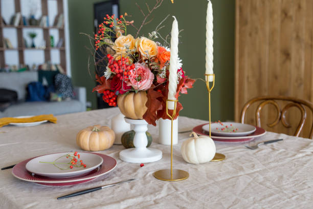 istock Seasonal table setting with plates, flowers and candles 1201425247