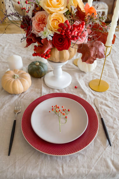 istock Table place with flowers, candles and fork and knife 1201425313