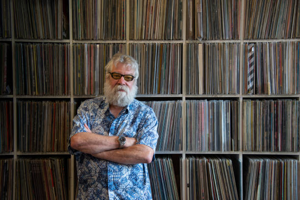 istock Record collector with beard in front of his collection. looking at camera 1201426113