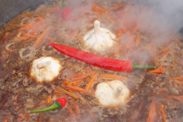 istock Boiling carrots, garlic, red pepper for pilaff 1201426476