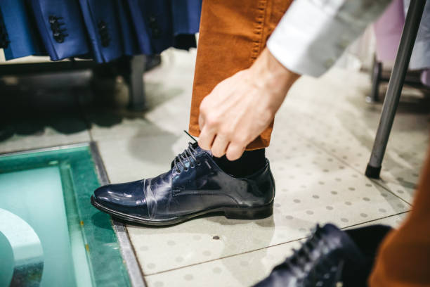 istock Man trying shoes in store 1201426971
