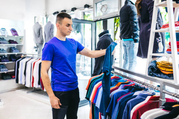 istock Man in clothing store 1201429206