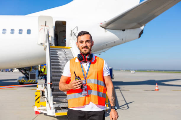 airport ground service man in front of airplane - ground crew audio imagens e fotografias de stock