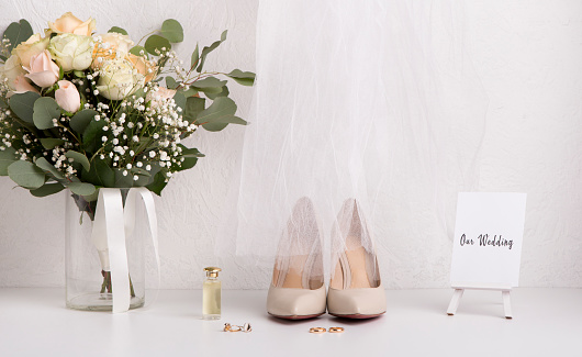 Wedding details. Bride accessories with bouquet and high heel shoes, copy space