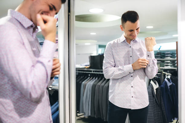 istock Man trying shirt in a store 1201429412