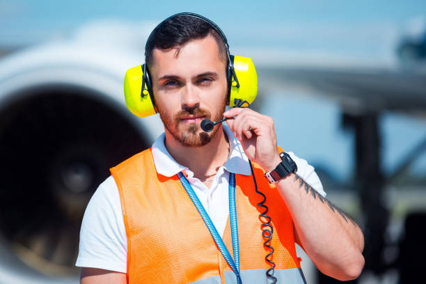 airport ground service, man in front of airplane - ground crew audio imagens e fotografias de stock