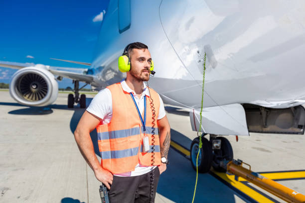 airport ground service, man in front of airplane - ground crew audio imagens e fotografias de stock