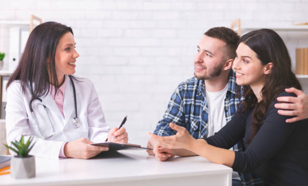 istock Young couple at doctor's appointment at clinic 1201429783