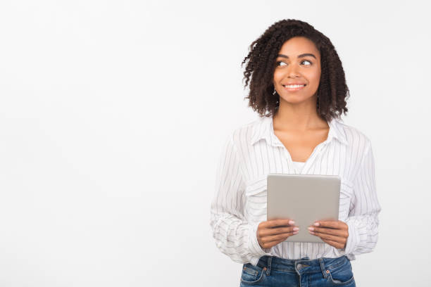 istock Afro woman with tablet looking at empty space 1201429900
