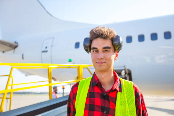 airport ground service, young man in front of aircraft - ground crew audio imagens e fotografias de stock