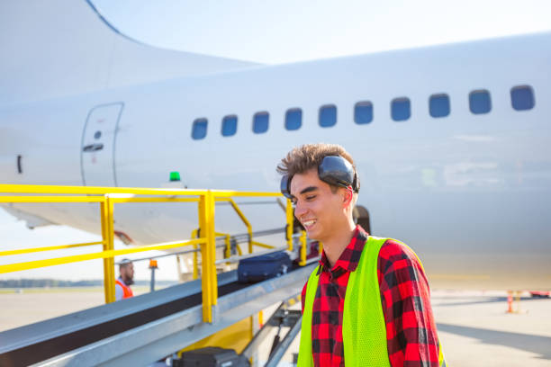 airport ground service, young man in front of aircraft - ground crew audio imagens e fotografias de stock