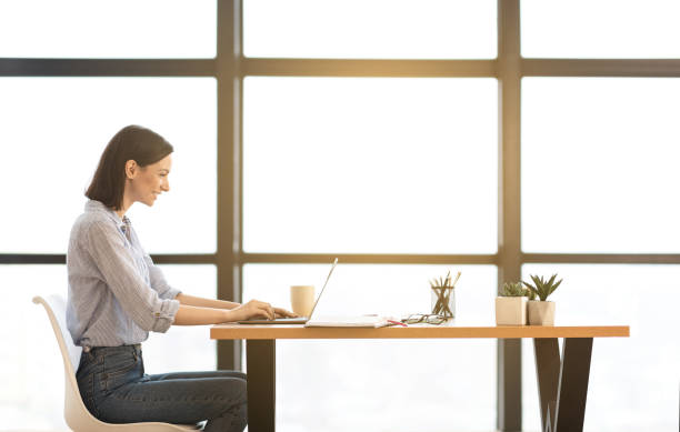 istock Beautiful girl working on her laptop at office 1201430754