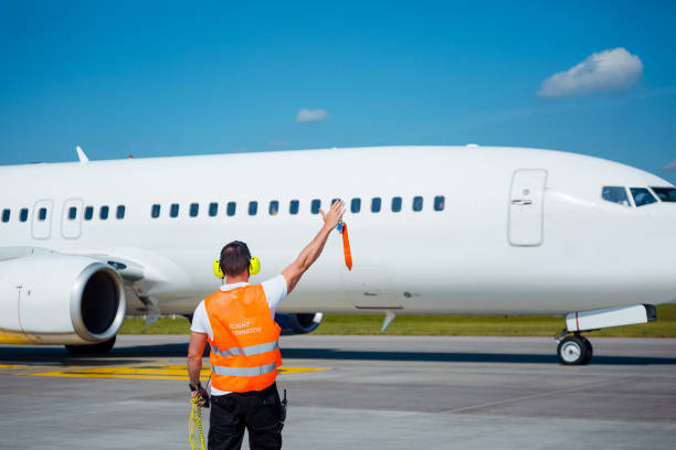 istock Airport service crew in front of airplane 1201431639
