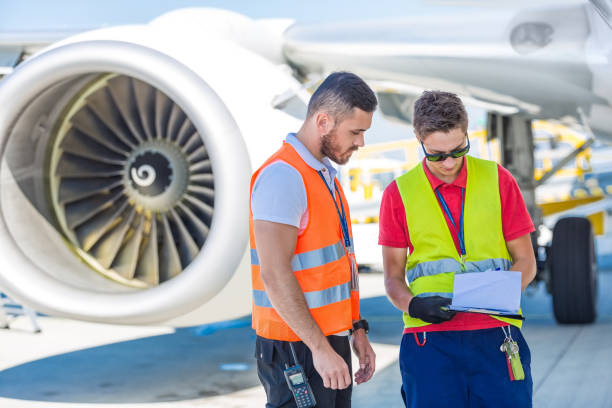 istock Airport service crew in front of airplane 1201431683