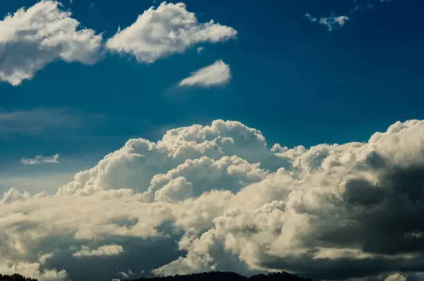 Formation of large cumulusnimbus cloud, under a deep blue sky.