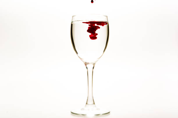 istock Red food coloring diffuse in water inside wine glass 1201433754
