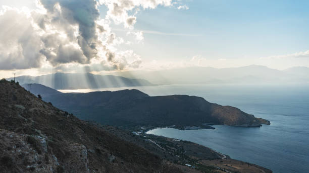 istock Bright light with sun rays and heavy clouds above the sea. Seascape with dramatic sky. 1201433974