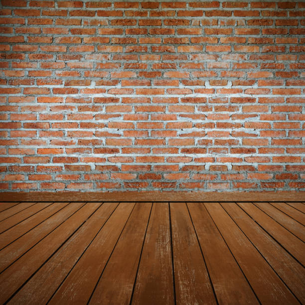 istock Empty room with brick wall  and wood floor 1201435597