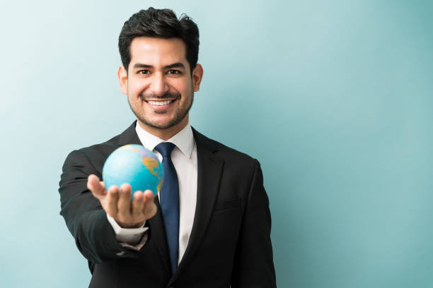 istock Latin Businessman With World Map Against Isolated Background 1201436709