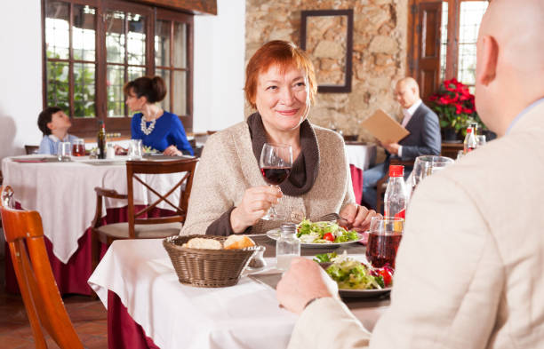 istock Mature woman with son in restaurant 1201437798