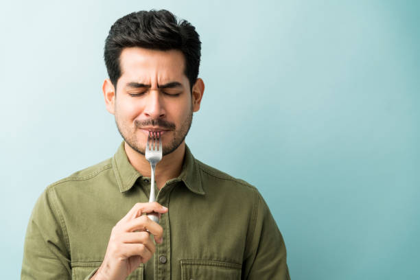 Hispanic Man Enjoying Food Over Blue Background