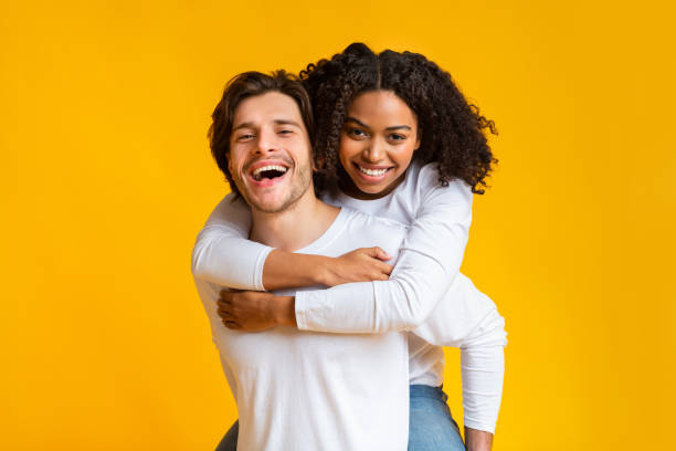 istock Piggyback ride. Affectionate guy carrying his afro girlfriend on back. 1201438171