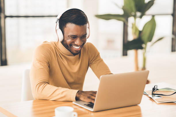istock Smiling african american businessman chatting online at work 1201438250