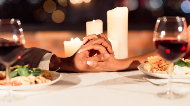 istock Unrecognizable Spouses Holding Hands Interlocking Fingers On Table In Restaurant 1201438292
