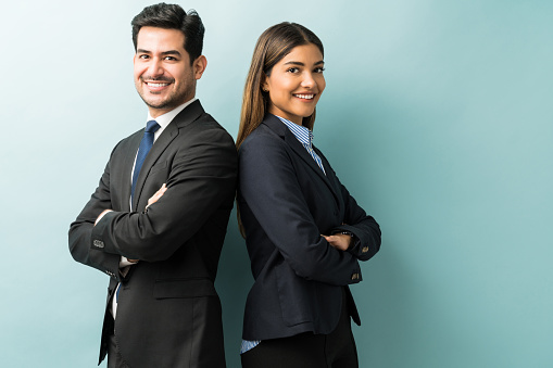 Business Colleagues Standing With Arms Crossed In Studio