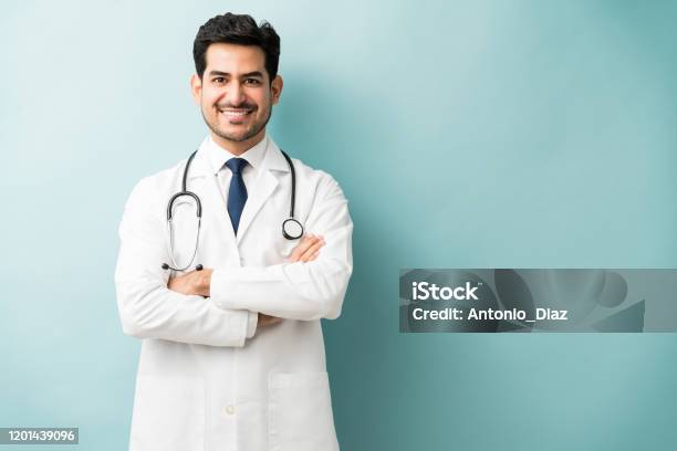 Male Medical Professional Is Confident In Studio Stock Photo - Download Image Now - Doctor, Latin American and Hispanic Ethnicity, Young Adult