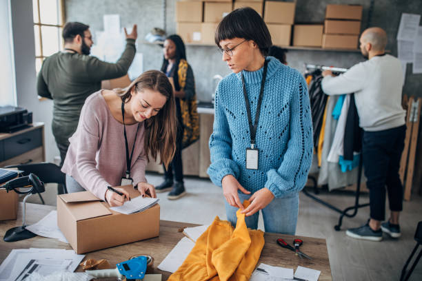 istock Diverse group of people arranging customers orders for drop shipping 1201441074