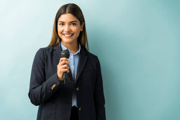 istock Pretty Businesswoman Giving Speech In Studio 1201442349