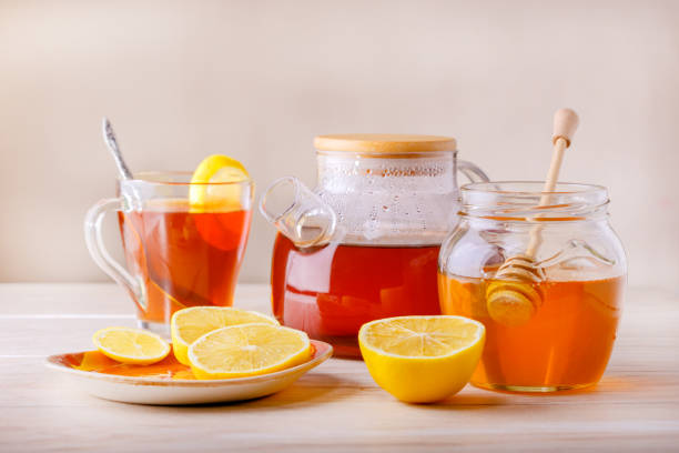 istock Fruit and herbal tea with lemon and honey on table 1201442540