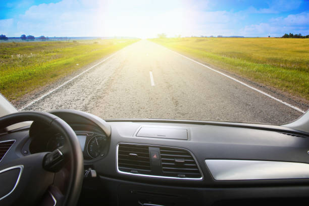 istock View from the windshield of a car driving along a sunset road 1201446047